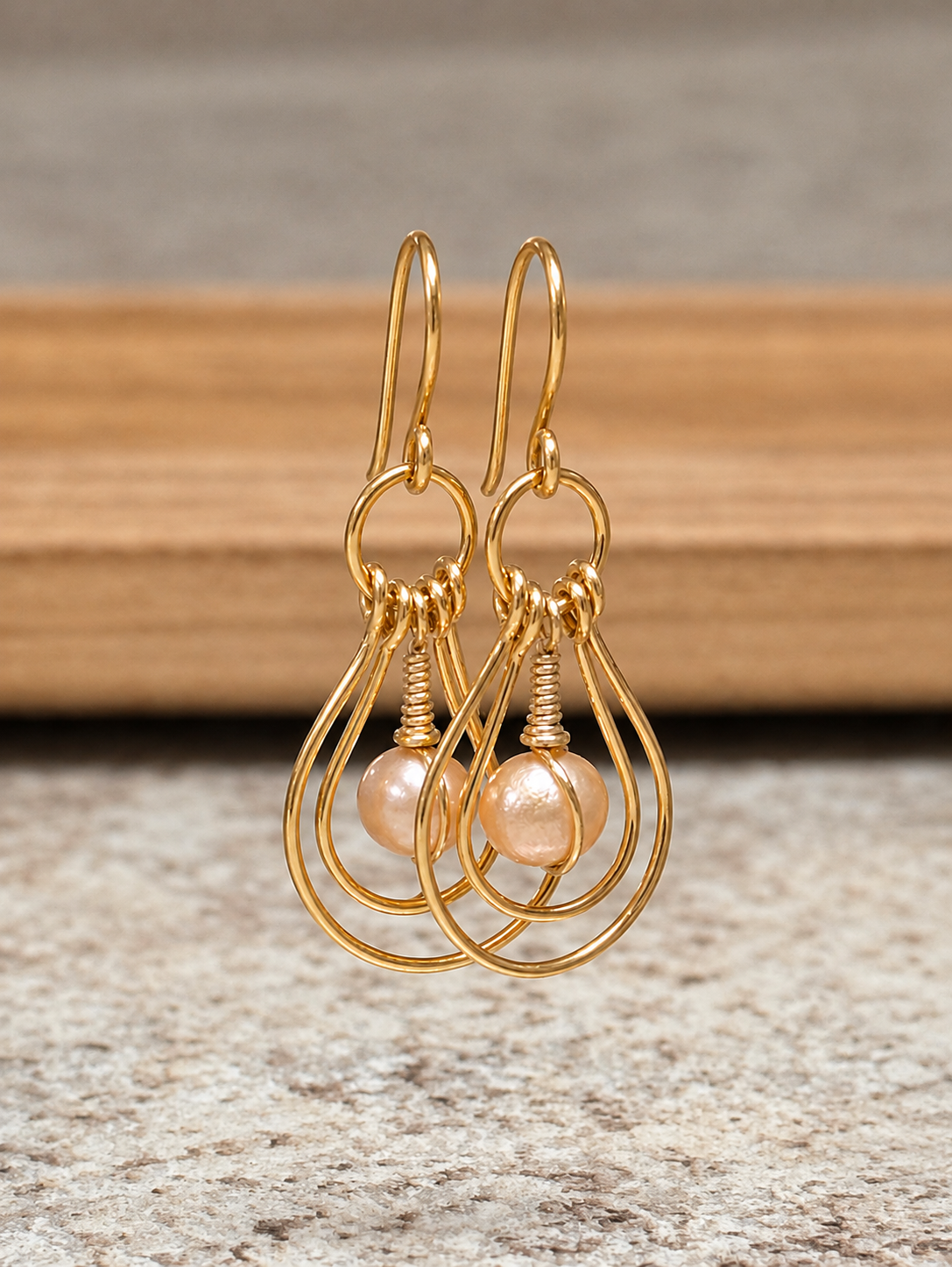 Handcrafted gold-plated double nested teardrop hoop earrings with wire-wrapped Edison freshwater pearl drops.