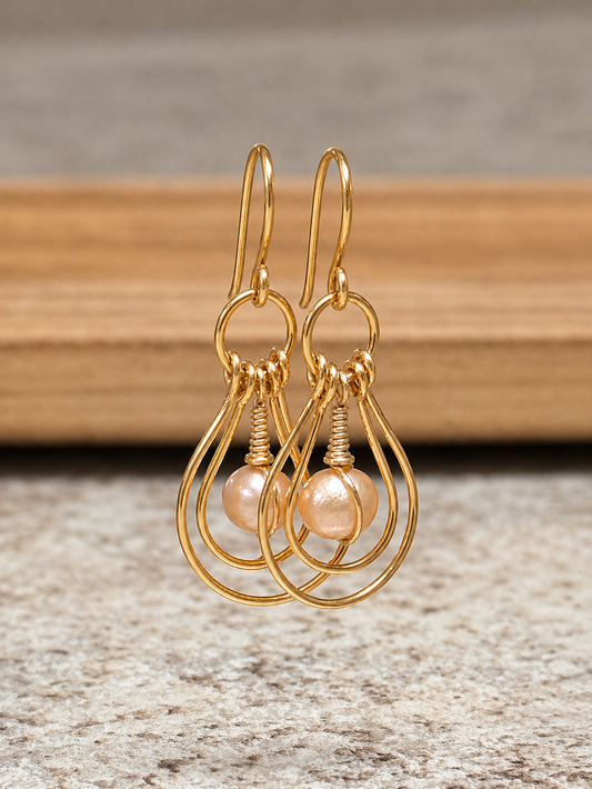 Handcrafted gold-plated double nested teardrop hoop earrings with wire-wrapped Edison freshwater pearl drops.